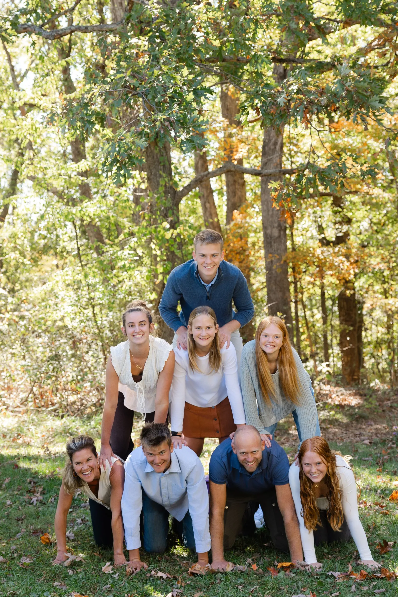 Jared Swift and his family forming a human pyramid outdoors in the fall